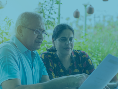 two older patients reading a medical bill 